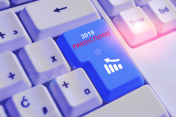 Conceptual hand writing showing 2019 Predictions. Concept meaning statement about what you think will happen in 2019 White pc keyboard with note paper above the white background