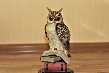 owl figurine on laminate and beige background