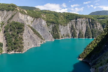 Obraz premium Monteynard, Isere, France - Monteynard-Avignonet lake on Drac river. La Mure Railway on the top of the cliff