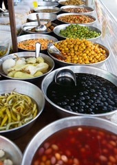 salting olives, onion, peppers and other salting sold on outdoor spanish market.