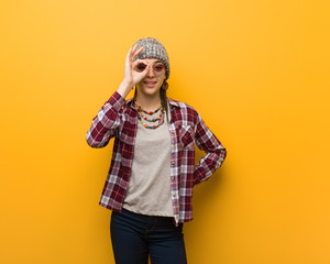 Young hippie natural woman confident doing ok gesture on eye