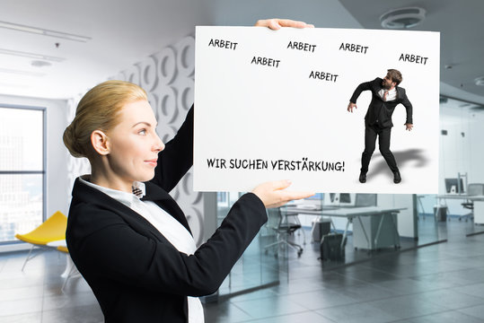 woman holding sign with German message "we are hiring" 