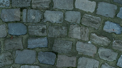 Cobblestone road. Background. Texture.  Vintage stone gray pavers on street