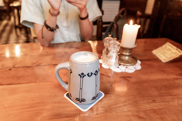Vintage cup of beer or ale in retro tavern