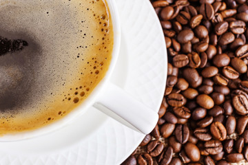 White cup with hot americano on a saucer. Coffee beans on burlap. The concept of making coffee. Flat lay, top view, minimalism.