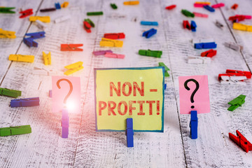 Handwriting text NonProfit. Conceptual photo not making or conducted primarily to make profit organization Scribbled and crumbling sheet with paper clips placed on the wooden table
