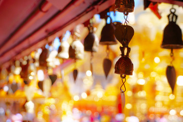 Fototapeta premium Small bells hang on roof in the temple with background gold pagoda
