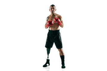 Full length portrait of muscular sportsman with prosthetic leg, copy space. Male boxer in red gloves. Isolated shot on white studio background.