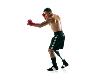 Full length portrait of muscular sportsman with prosthetic leg, copy space. Male boxer in red gloves. Isolated shot on white studio background.