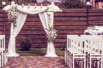 Wedding decoration ceremony. Arch of flowers on the summer area of the restaurant