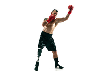 Full length portrait of muscular sportsman with prosthetic leg, copy space. Male boxer in red gloves. Isolated shot on white studio background.