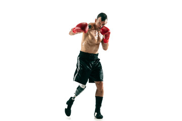 Full length portrait of muscular sportsman with prosthetic leg, copy space. Male boxer in red gloves. Isolated shot on white studio background.