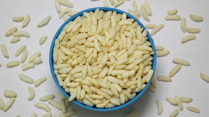 Puffed rice on the blue bowl with white background