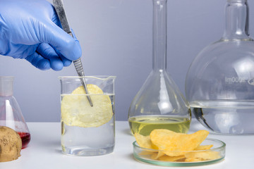 Food safety laboratory procedure, analysing potato chips from the market. Workplace lab assistant.