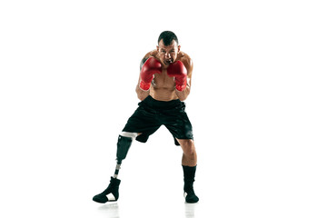 Fototapeta na wymiar Full length portrait of muscular sportsman with prosthetic leg, copy space. Male boxer in red gloves. Isolated shot on white studio background.