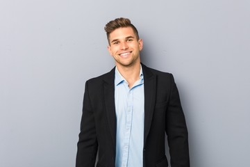 Young handsome caucasian man happy, smiling and cheerful.
