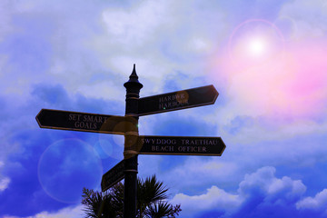 Writing note showing Set Smart Goals. Business concept for giving criteria to guide in the setting of objectives Road sign on the crossroads with blue cloudy sky in the background
