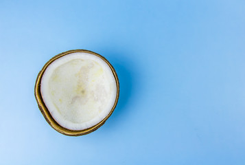 ugly food. old split coconut on a blue background