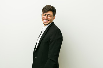 Fototapeta premium Young business hispanic man looks aside smiling, cheerful and pleasant.