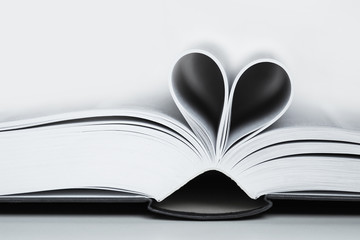 Open book, black and white image. Heart shaped book sheets