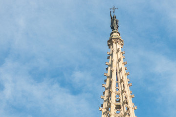 Fototapeta na wymiar Statue of Saint Eulalia, patron saint of the city, on the spire of the Metropolitan Cathedral Basilica of Barcelona, located in the gothic quarter in Catalonia, Spain