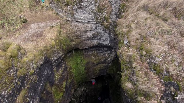 Sumgan-Kutuk karst cave. Descent cavers in the cave. Aerial view.