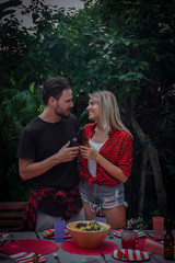 couple in love having a barbecue party in nature. barbecue and party.