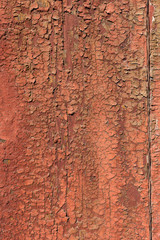 Old and peeling paint Over time, the red paint peeled off from the old boards and the wood texture cracked. Vintage Abstract Grunge Background