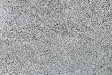 Gray textured cement wall background with fine concrete chips. Construction backgrounds