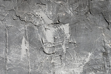 The texture of gypsum or alibaster cracked plaster on the wall is a thick layer. Gradient gray...
