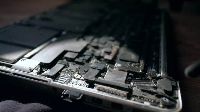 Computer Service. Master cleans dust the inside of the laptop with air pear. Slowmotion. Close up. Tech Support Electronic Devices Concept.