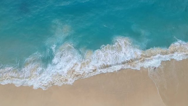 Sea or ocean surf with sandy beach, aerial view