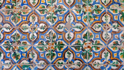 Old traditional arista tiles found in Seville, floral motifs forming out of four tiles, spectacular designs with extensive historical and artistic value covering ceilings and walls in Andalusia, Spain