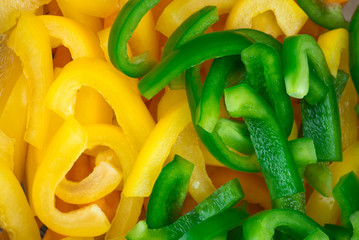 Sliced pepper. Slices of yellow and green bell peppers