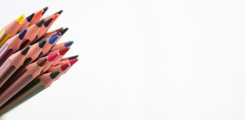 pencils of many colors that appear from the left part of the image