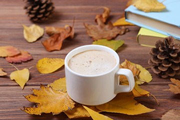 Autumn composition with leaves and a cup of coffee.