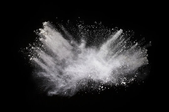 White powder explosion on black background. Colored cloud. Colorful dust explode. Paint Holi.