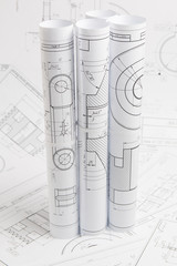 paper engineering drawings of industrial parts and mechanisms