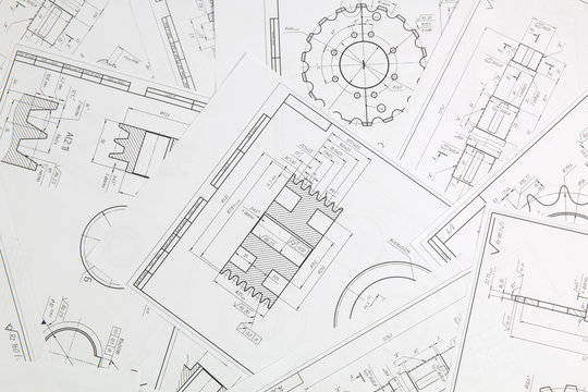 paper engineering drawings of industrial parts and mechanisms