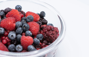 Various colourful berries in glass blow on white background, strawberry, raspberry, blackberry, blueberry, healthy food concept.