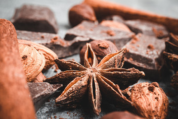 Star anise, chocolate cubes and nuts, close-up view