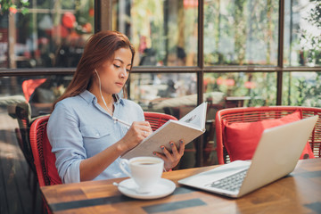 Asian woman drinking coffee in vintasg color tone