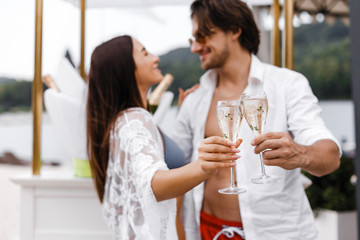 Romantic couple toasting wine glasses outdoors
