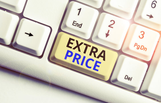 Text sign showing Extra Price. Business photo showcasing extra price definition beyond the ordinary large degree White pc keyboard with empty note paper above white background key copy space