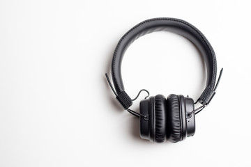 Black wireless headphones on a white background, top view