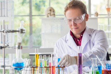 Fototapeta premium Young Caucasian scientists making testing with test tube while doing research at science laboratory.