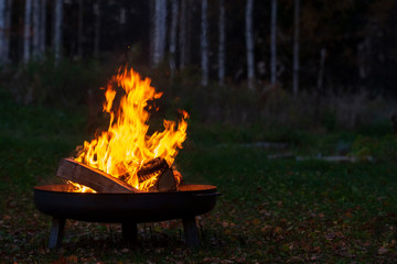 Campfire in a firebowl, autumn evening