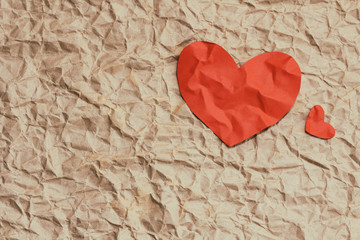 Paper red heart on crumpled craft paper. Background textures. Love. Postcard. Health insurance. Heart function test. Your text space.