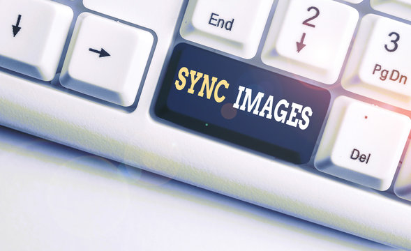 Conceptual hand writing showing Sync Images. Concept meaning Making photos identical in all devices Accessible anywhere White pc keyboard with note paper above the white background