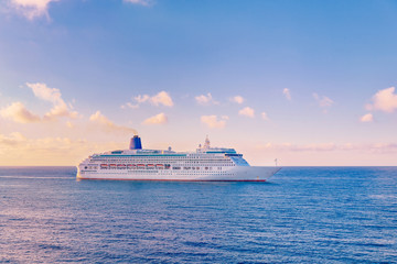 Fototapeta na wymiar Luxury cruise ship sunset in blue sea with clouds